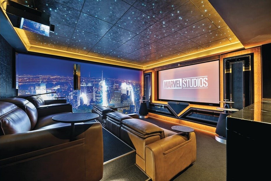 Beatufil home cinema with Marvel Studios on the screen and a city landscape lit up on the wall when the Toorak home auotmation renovation was complete